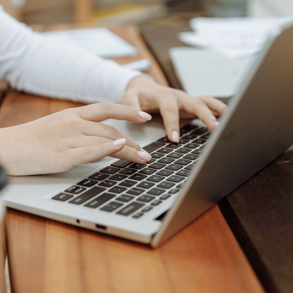 Woman typing on a laptop