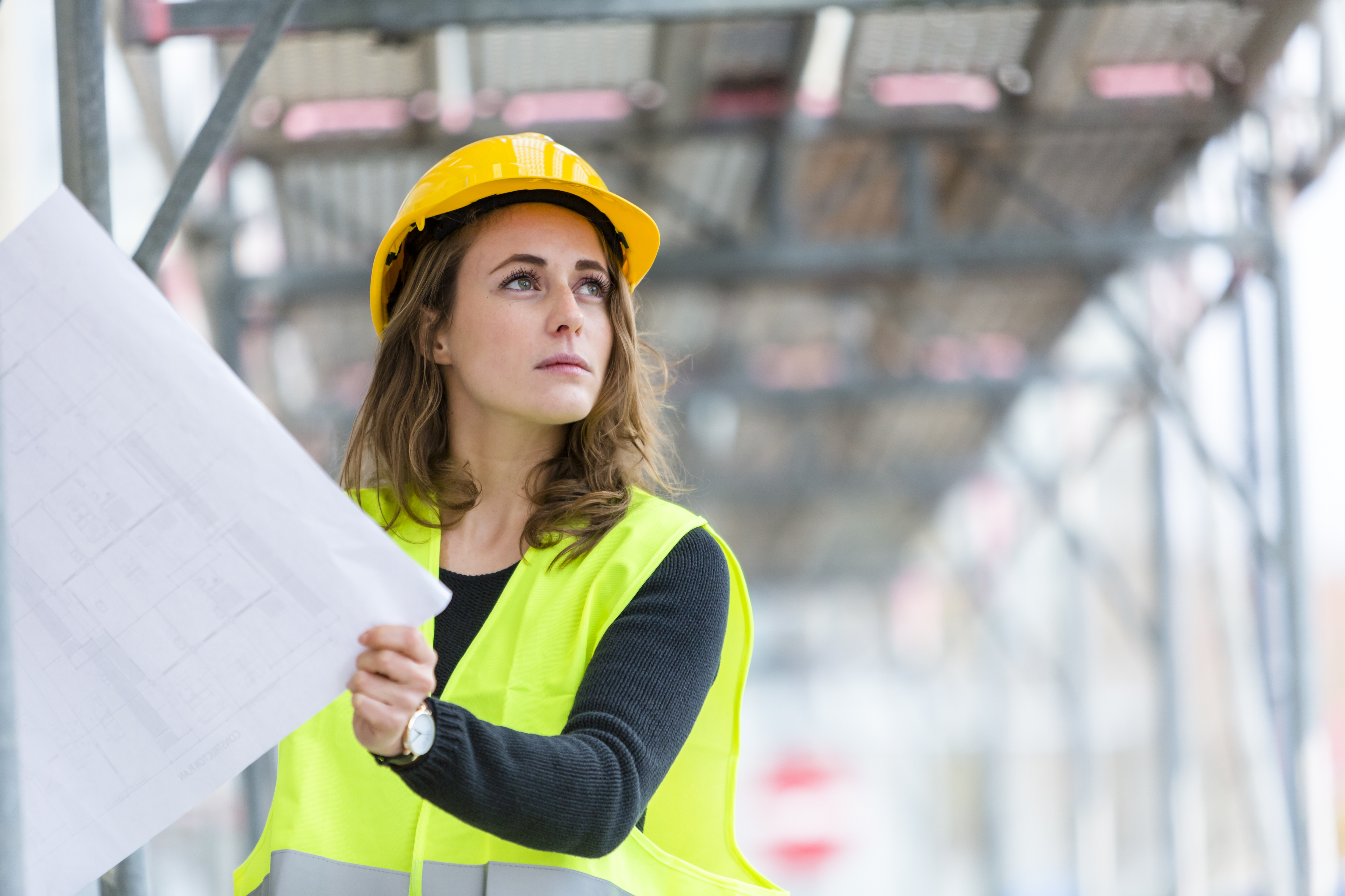 Woman in Construction Hat With Paper