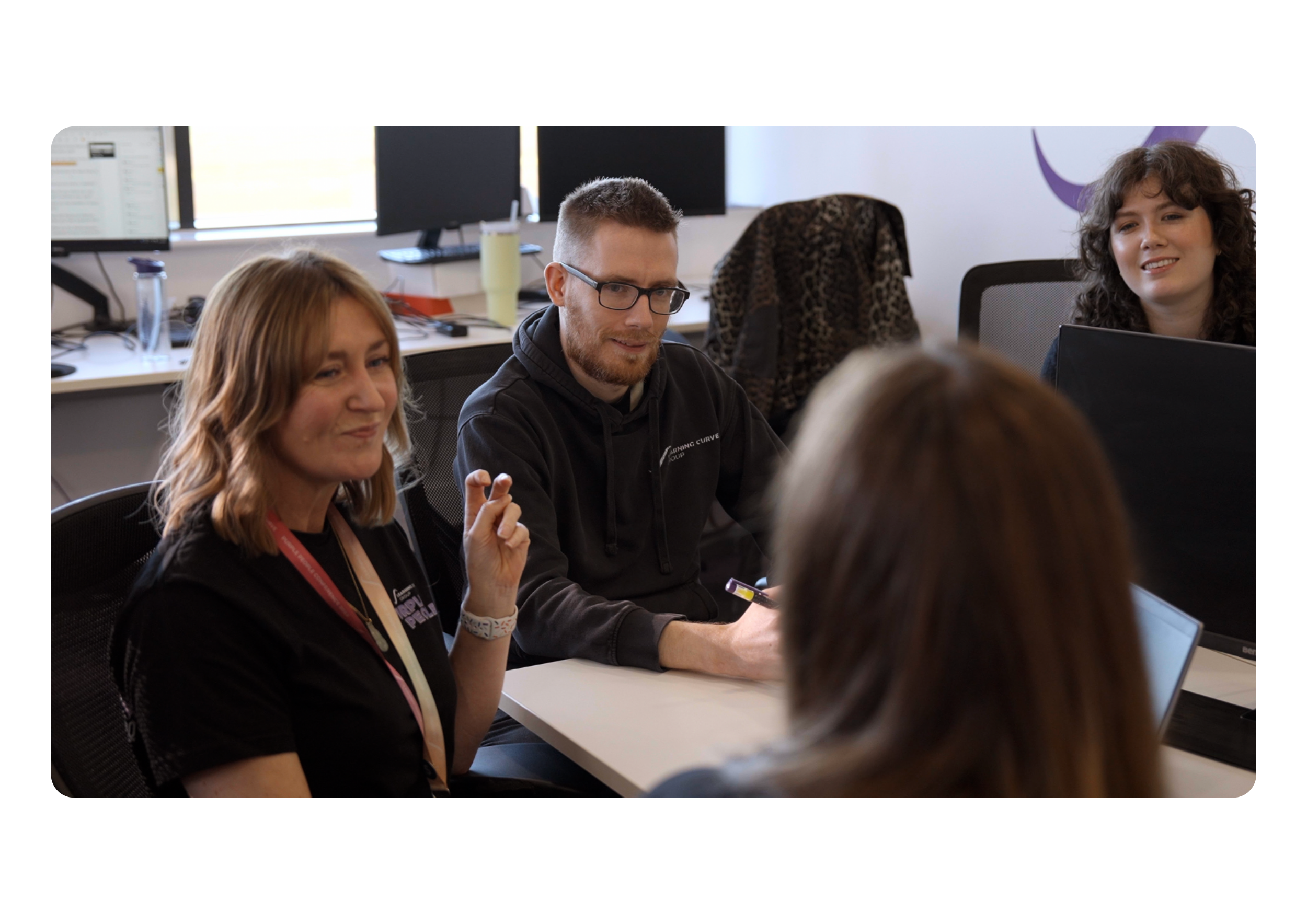 Staff members at a table chatting